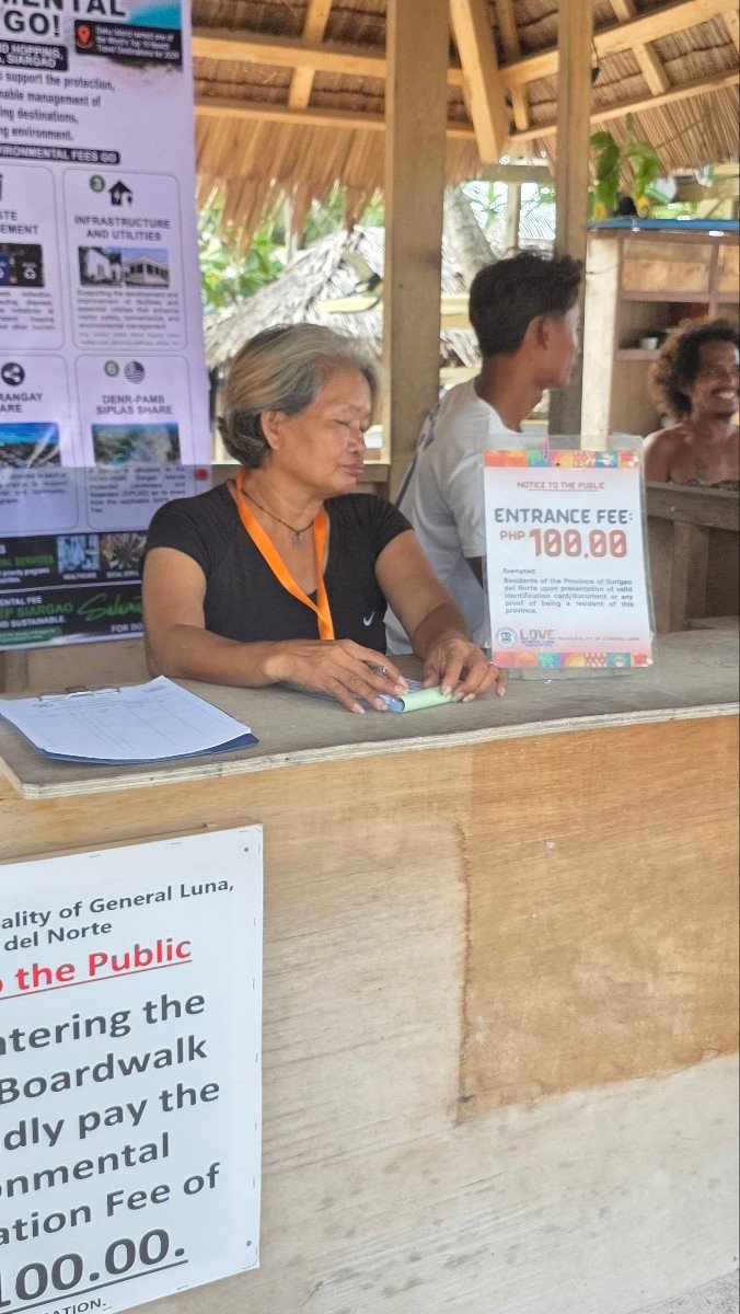 Entrance fee sign at Cloud 9, Siargao, displaying PHP 100.00